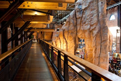 elevated walkway of steal, wood, and climbing wall through an REI flagship store in Denver, Colorado
