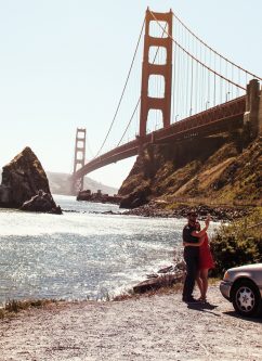 a couple taking a selfie in front of the golden gate bridge, marin county, california
