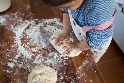 preschooler kneading bread for baking bread, montessori