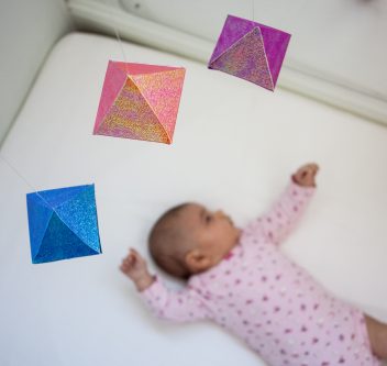 baby looking at montessori octahedron mobile