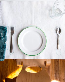 montessori placemat with child-sized silverware, glassware, and plates