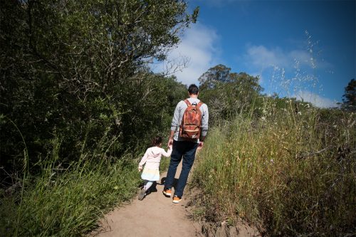 father and preschooler hiking in glen park canyon, san francisco, california